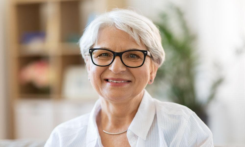 image of older woman with glasses posing for the camera