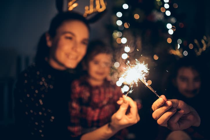 family holding sparklers for new years celebration